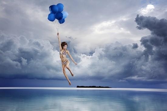 A Girld in flying in the photo that is a nice expample Amazing Photography Manipulation by Tim Tadder