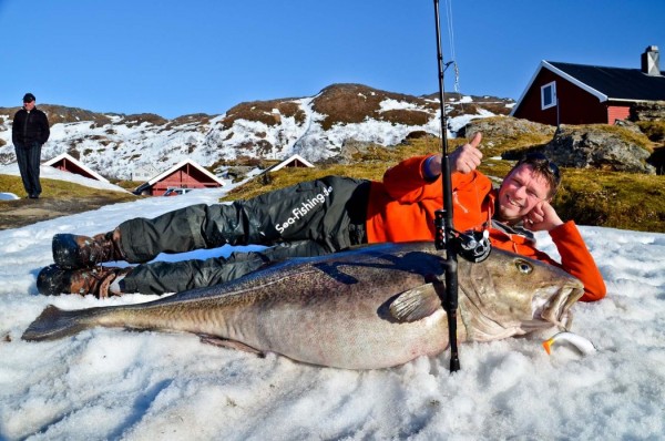 Michael Eisele poses with cod caught them in Norway
