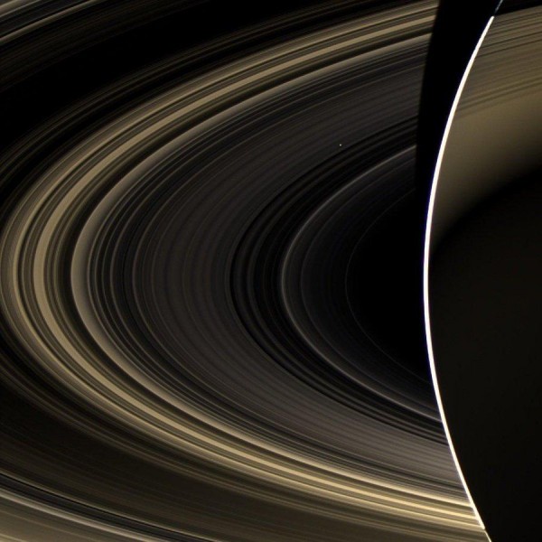 Rings of Saturn and a barely noticeable through them Venus